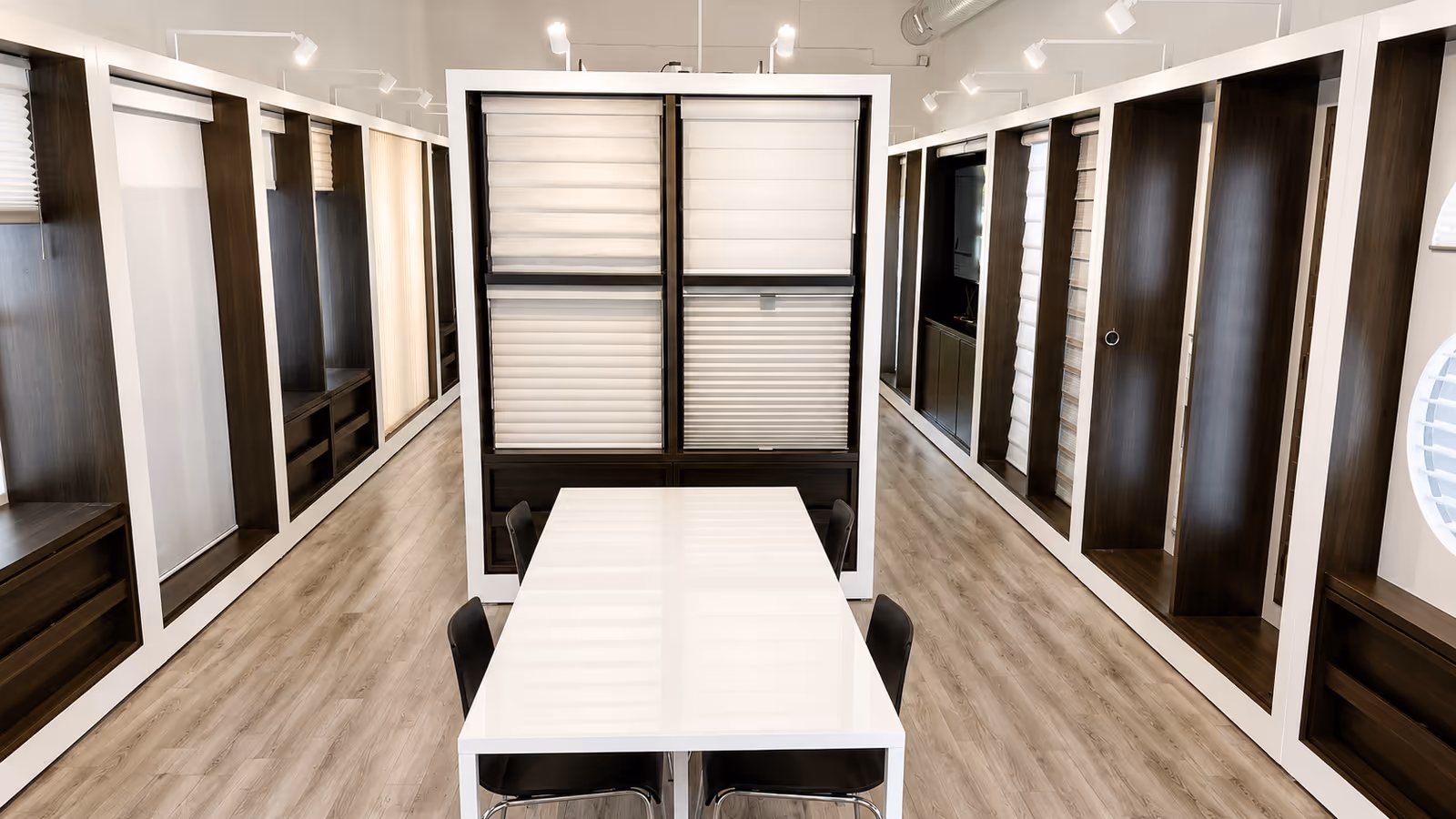 The La Grange Window Coverings showroom in Windsor, CA — Hunter Douglas display walls and a consultation table where Sonoma County clients review full-size fabric and material samples