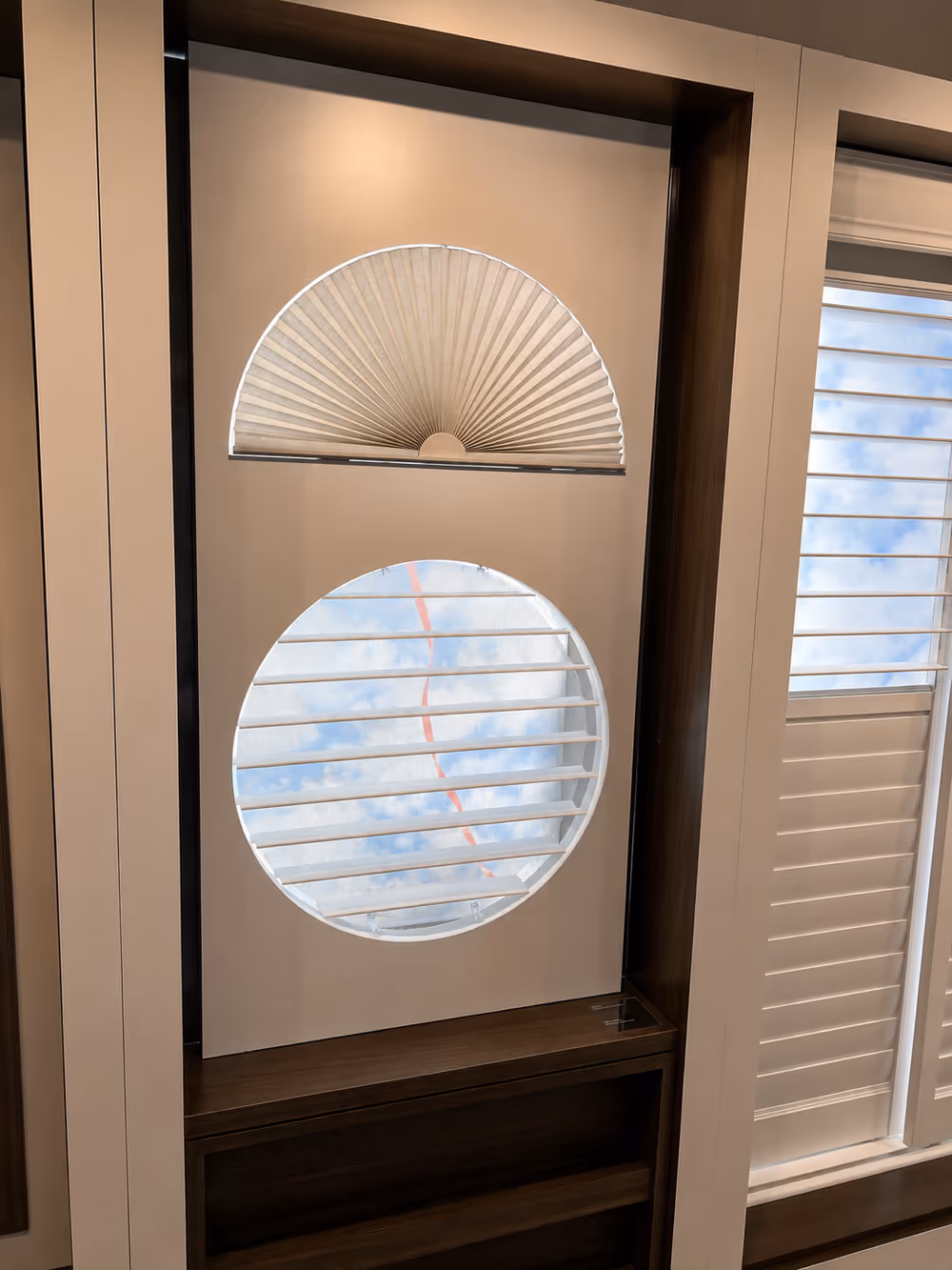 Custom arch-shaped window covering above a circular porthole specialty window, precision-templated by La Grange Window Coverings in Sonoma County
